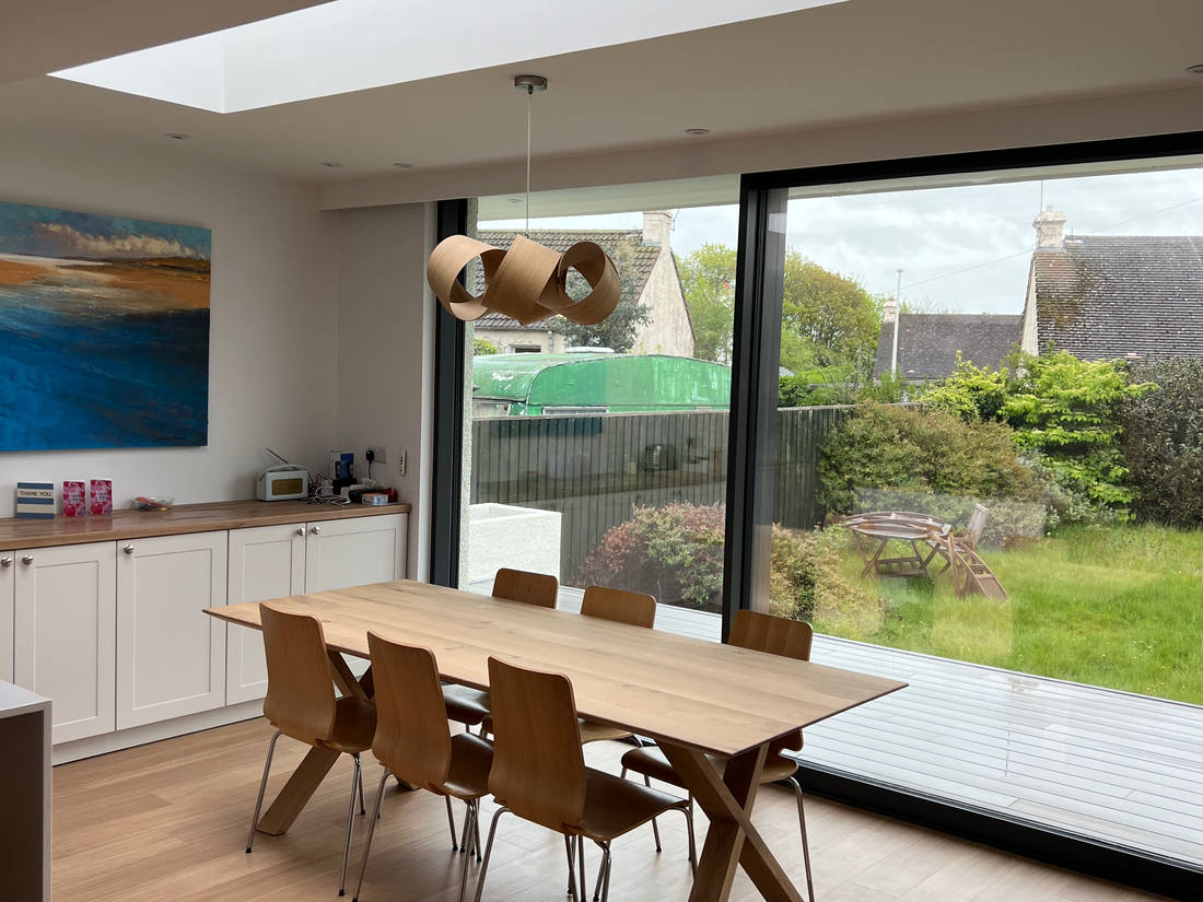 Open-plan dining room with floor-to-ceiling glazing onto the garden, Gullane
