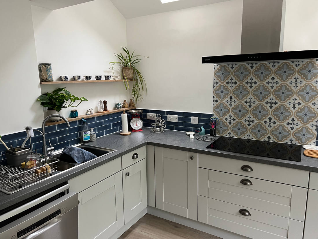 Kitchen with a blue and white patterned tile splashback and open shelving, Rock Road